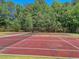 Tennis court with net and wooden fence at 211 Brailsford Rd, Summerville, SC 29485