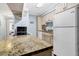 Modern kitchen with granite countertops and white appliances at 219 Sea Cloud Cir, Edisto Island, SC 29438