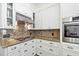 Kitchen with granite counters, white cabinets, and gas cooktop at 2212 Salt Wind Way, Mount Pleasant, SC 29466