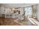 Kitchen dining area with hardwood floors, a table for six, and a large window at 2270 Tillage St, Mount Pleasant, SC 29466