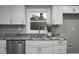 White shaker cabinets, granite counters, and stainless steel sink at 2334 Falcon Rd, North Charleston, SC 29406
