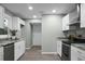 Modern kitchen with white cabinets, granite countertops, and stainless steel appliances at 2334 Falcon Rd, North Charleston, SC 29406