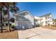 Two-car garage with light-grey doors and a spacious driveway at 2427 Jasper Patterson Dr, Johns Island, SC 29455