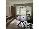 Sunlit dining room featuring a round table and brick accent wall at 2430 Thaxton St, Charleston, SC 29414