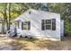 Side view of a renovated light gray house with black shutters and a small porch at 2720 W Surrey Dr, North Charleston, SC 29405