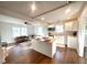 Open concept kitchen with island, white cabinets, and hardwood floors at 2720 W Surrey Dr, North Charleston, SC 29405