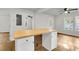 Modern kitchen island with white shaker cabinets and wood countertop at 2720 W Surrey Dr, North Charleston, SC 29405