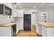 Modern kitchen with white cabinets, butcher block countertops, and black appliances at 2720 W Surrey Dr, North Charleston, SC 29405