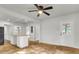 Living room with hardwood floors, open concept kitchen and a door to exterior at 2720 W Surrey Dr, North Charleston, SC 29405