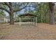 Backyard view showing a shaded area with a simple wooden shelter at 2736 Bonds Ave, North Charleston, SC 29405