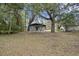 Large backyard featuring mature trees and a covered patio area at 2736 Bonds Ave, North Charleston, SC 29405