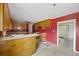 Wood kitchen cabinets and red walls, ready for updates at 2736 Bonds Ave, North Charleston, SC 29405