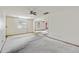 Large living room with worn carpet and ceiling fan at 2736 Bonds Ave, North Charleston, SC 29405