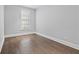 Simple bedroom with hardwood floors and large window at 28 Dereef Ct, Charleston, SC 29403