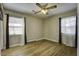 Light-filled bedroom with hardwood floors and two windows at 303 Holly Avenue Ave, Goose Creek, SC 29445