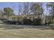 Brick ranch house with side yard and trees at 303 Holly Avenue Ave, Goose Creek, SC 29445