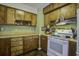 Bright kitchen offers ample wood cabinetry and a stovetop at 303 Holly Avenue Ave, Goose Creek, SC 29445