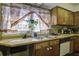 Cozy kitchen features wood cabinets, double sink, and window overlooking the backyard at 303 Holly Avenue Ave, Goose Creek, SC 29445