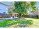 Fenced backyard with firepit and large tree at 33 Cypress St, Charleston, SC 29403