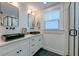 Modern bathroom with black sinks, white cabinets, and a glass shower at 33 Cypress St, Charleston, SC 29403