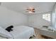 Bedroom with a queen bed, gray couch, and ceiling fan at 33 Cypress St, Charleston, SC 29403