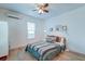 Bright bedroom with a teal colored bed and ceiling fan at 33 Cypress St, Charleston, SC 29403