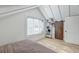 Bedroom with vaulted ceiling, barn door, and a rustic-style bookshelf at 33 Cypress St, Charleston, SC 29403
