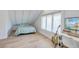 Cozy bedroom with sloped ceilings, wood floors, and a home office setup at 33 Cypress St, Charleston, SC 29403