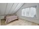 Bright bedroom with sloped ceilings, large window, and light brown bedding at 33 Cypress St, Charleston, SC 29403