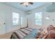 Bedroom with a teal colored bed and two windows at 33 Cypress St, Charleston, SC 29403