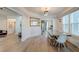 Bright dining room features a large metal table and hardwood floors at 33 Cypress St, Charleston, SC 29403