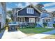 Exterior view of charming dark-painted home with front porch at 33 Cypress St, Charleston, SC 29403