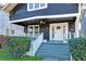 Quaint front porch with white railings and a ceiling fan at 33 Cypress St, Charleston, SC 29403