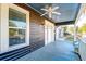 Inviting front porch with white columns, ceiling fan, and light fixture at 33 Cypress St, Charleston, SC 29403
