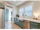 Updated kitchen with farmhouse sink, teal cabinets, and stainless steel appliances at 33 Cypress St, Charleston, SC 29403