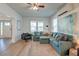 Relaxing living room with teal sectional sofa and hardwood floors at 33 Cypress St, Charleston, SC 29403
