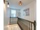Upstairs hallway with framed photos and dark wood railing at 33 Cypress St, Charleston, SC 29403