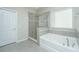 Bathroom with soaking tub, walk-in shower, and gray tile flooring at 394 Sanctuary Park Dr, Summerville, SC 29486