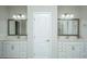 Double vanity bathroom with white cabinets and framed mirrors at 394 Sanctuary Park Dr, Summerville, SC 29486