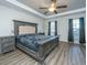 Spacious main bedroom with large bed, ceiling fan, and gray wood flooring at 394 Sanctuary Park Dr, Summerville, SC 29486