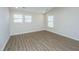 Bright bedroom with wood-look floors and two windows with blinds at 394 Sanctuary Park Dr, Summerville, SC 29486