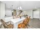 Bright dining room with a farmhouse table and chairs, and view of kitchen at 394 Sanctuary Park Dr, Summerville, SC 29486