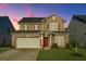 Two-story house with brick and siding, a double-car garage, and a manicured lawn at 394 Sanctuary Park Dr, Summerville, SC 29486