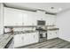 White kitchen cabinets and granite countertops at 394 Sanctuary Park Dr, Summerville, SC 29486