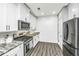 Modern kitchen with white cabinets, granite countertops, and stainless steel appliances at 394 Sanctuary Park Dr, Summerville, SC 29486