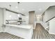 Modern kitchen with white cabinets, granite countertops, and stainless steel appliances at 394 Sanctuary Park Dr, Summerville, SC 29486
