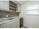 Small kitchenette with sink, mini-fridge, and shelving at 394 Sanctuary Park Dr, Summerville, SC 29486
