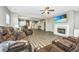 Open living room with fireplace, TV, and leather reclining furniture; view of kitchen and stairs at 394 Sanctuary Park Dr, Summerville, SC 29486