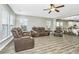 Open living room with a view into the kitchen and dining area, featuring comfortable reclining furniture at 394 Sanctuary Park Dr, Summerville, SC 29486