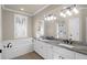 Elegant bathroom with double vanity, granite countertop, and a soaking tub at 4154 Jean Laffite Rd, Hollywood, SC 29449